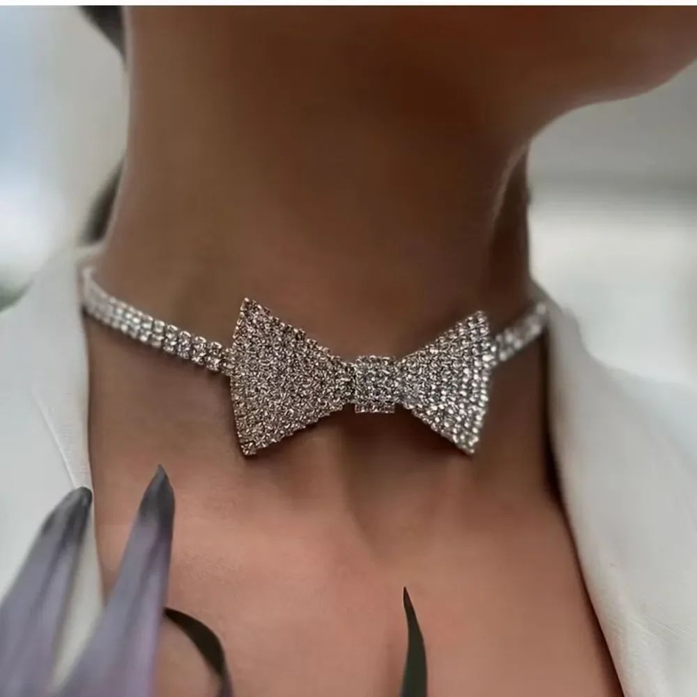 Dazzling crystal bow centerpiece on a sparkling choker. Elegant, eye-catching.